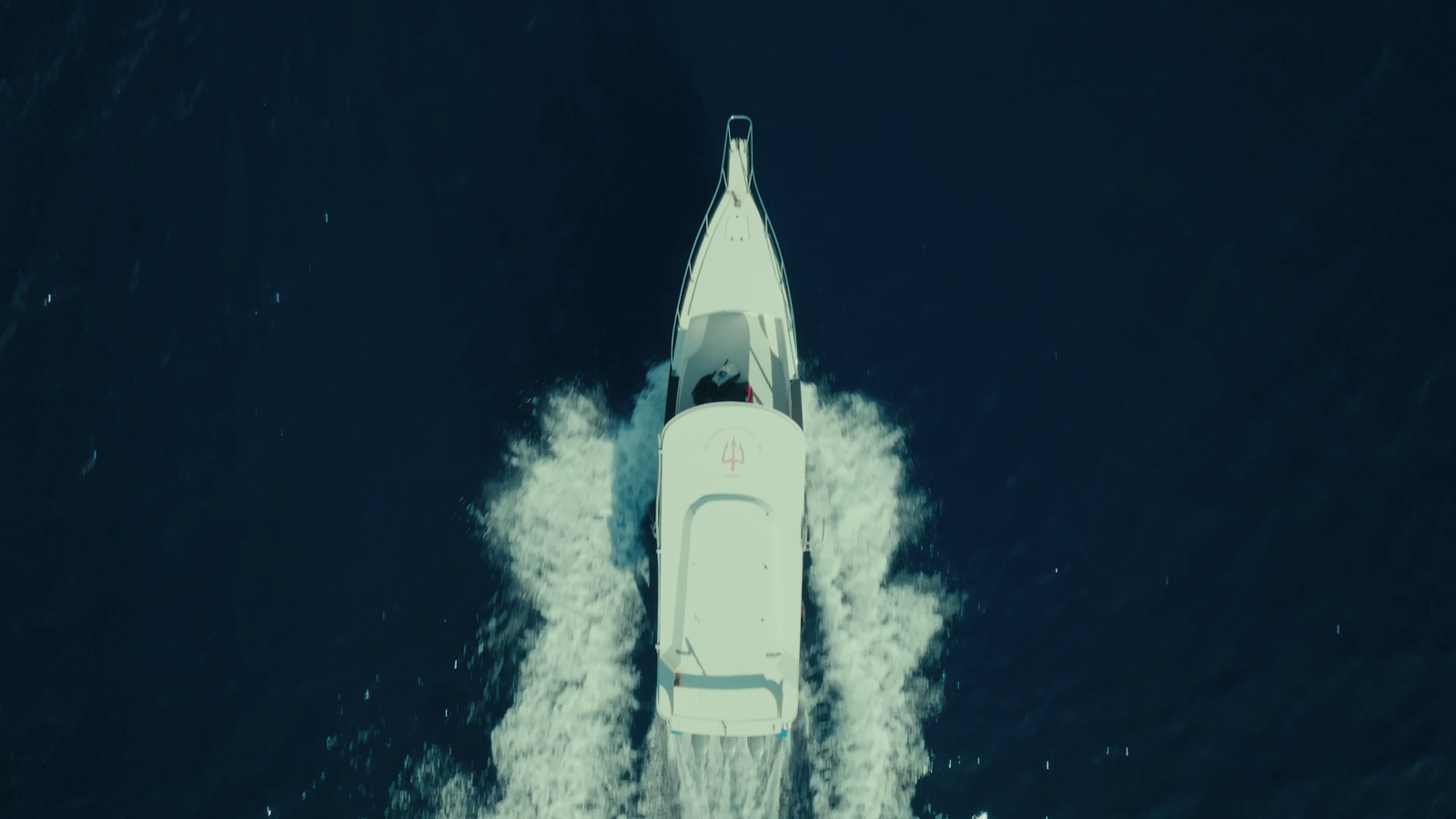 Aerial view of a Temple Diving dive boat heading out to sea off Nusa Penida, Bali