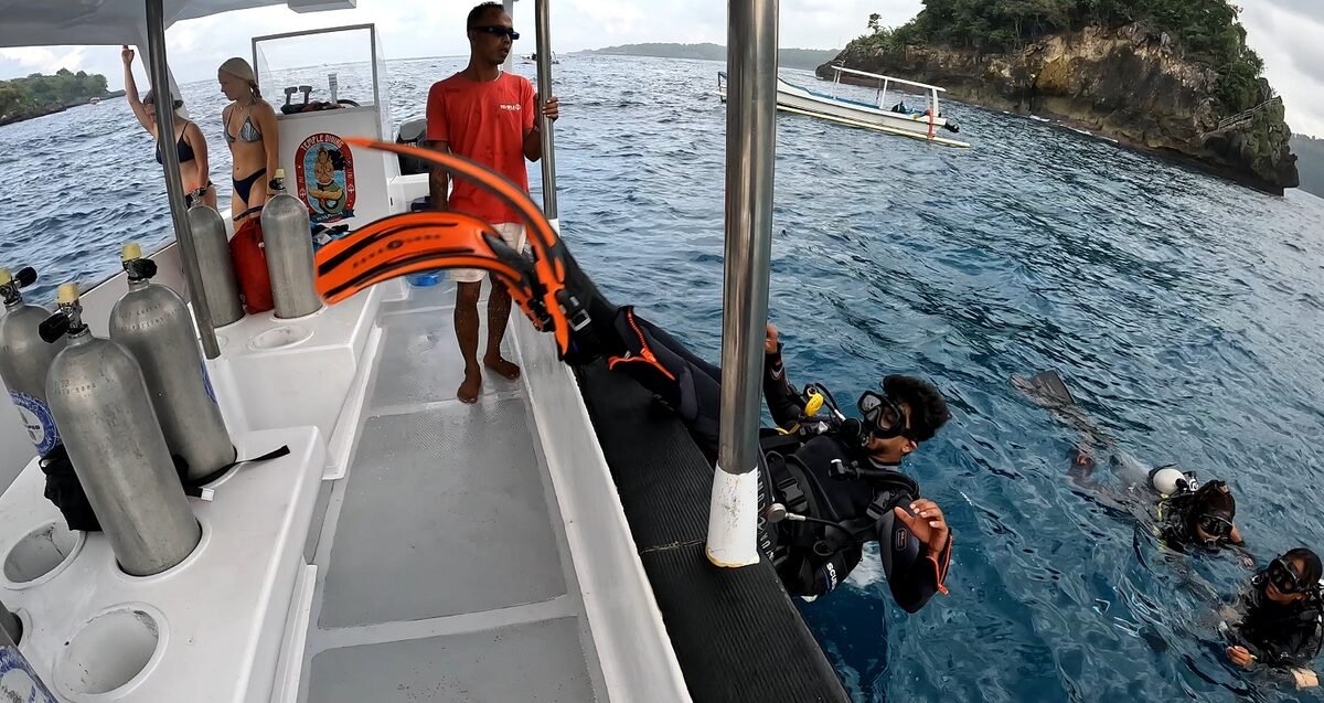 Temple Diving guide helping a diver into the water