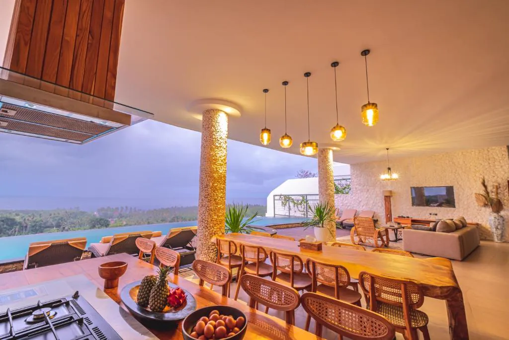 Kitchen and long dining table facing the sea