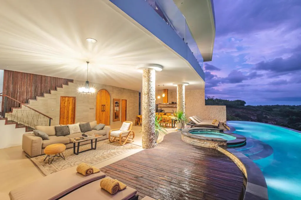 Living room opening onto the pool deck at dusk