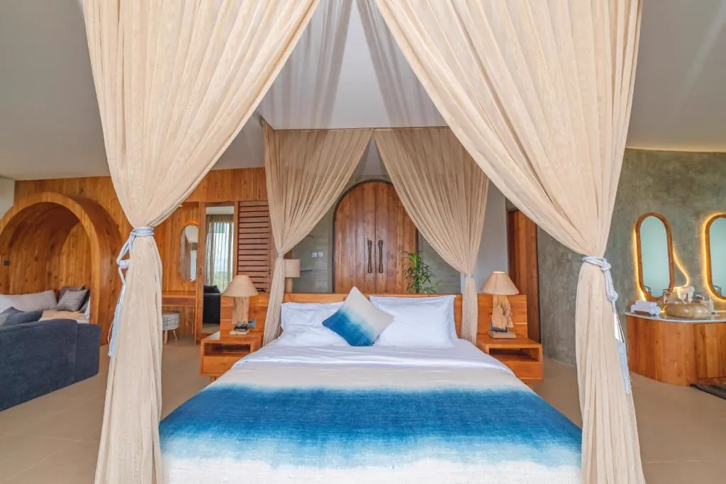 Master suite with canopy bed and lounge area