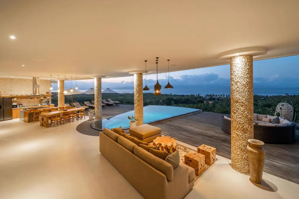 Open-plan living, dining and kitchen area facing the pool and the sea