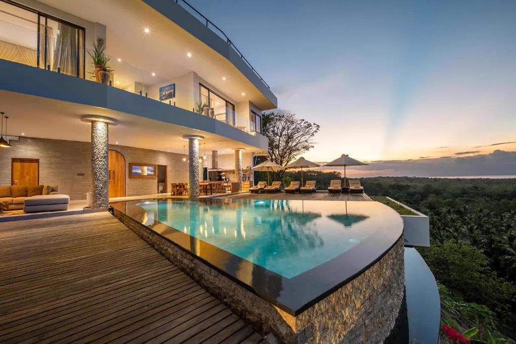 Infinity pool overlooking the palm trees at sunset