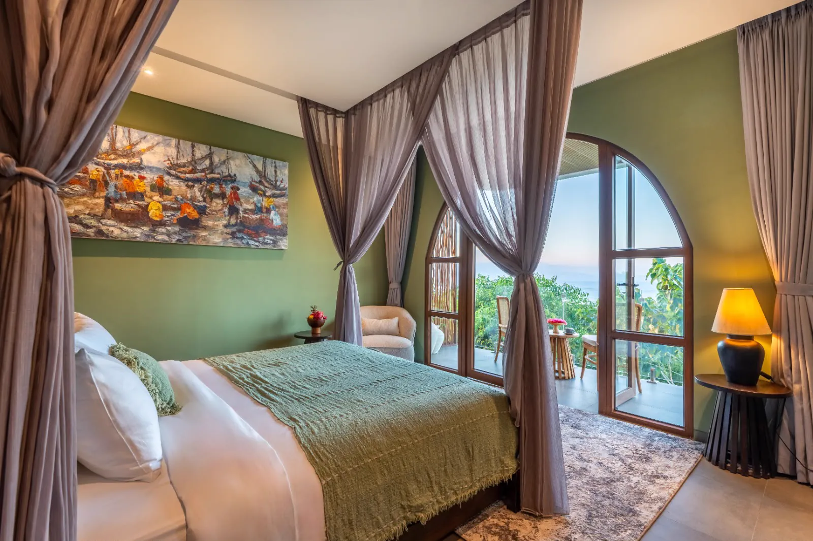 Canopy bedroom opening onto a balcony with a view